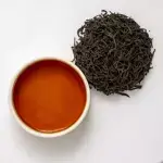 A view of cup of tea with tea leafs